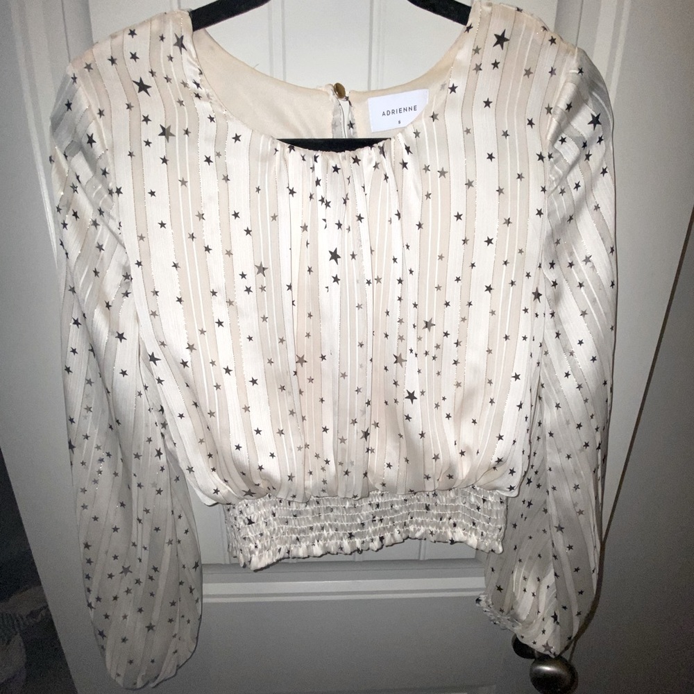 Cream silky blouse with star pattern. Size S/M.